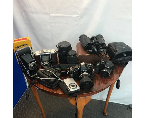 A Selection of vintage cameras to include Bellow Kodak Junior 1, Bellow camera, Tasco binoculars, Pentax Optio E60 10.1 Megap