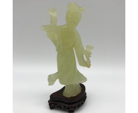 A Chinese hand carved Jade Geisha figurine sat upon a hardwood stand.