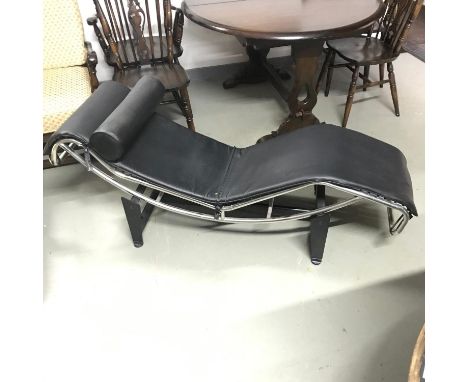 A vintage chrome and leather designer chaise longe. Designed on a metal stand 