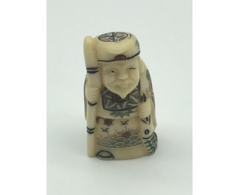 A Japanese hand carved netsuke figure of a Scholar, detailed with ornate gown and signed to the base by the artist. 