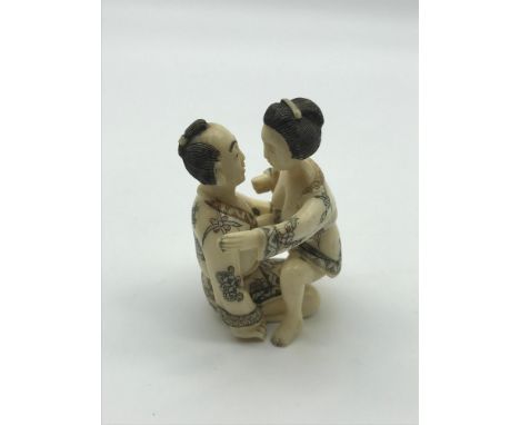 A Japanese Meiji period hand carved bone erotic netsuke figures. Highly detailed man and women Kamasutra figures. Man measure