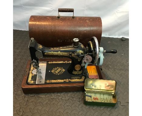 A Vintage Singer sewing machine serial number EB593352. Comes with instruction booklet and carry case top. 