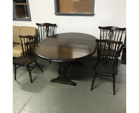 A vintage dark wood extending dining table together with two chairs and two carvers. Table measures 76x122x122cm not extended