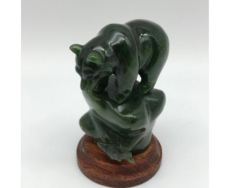 A Vintage hand carved oriental green jade bear figure sat upon a rock. Measures 8cm in height.
