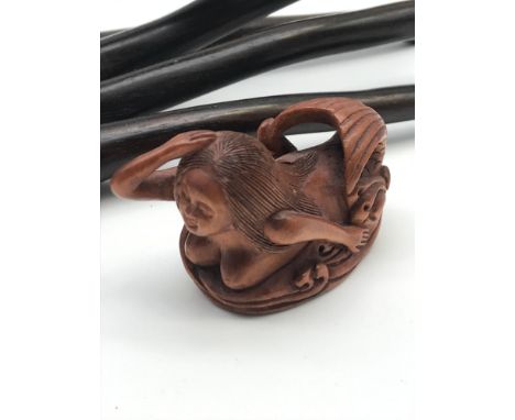 A Japanese hand carved netsuke figure of a mermaid, signed to the base by the artist. 