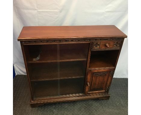 A Vintage Old Charm Bookcase unit. Detailed with linen press relief door, Acorn design handles and two sliding glass doors. M