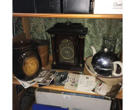 A Shelf of collectable odds to include Contemporary mantel clock, Art Deco tea kettle, Various old postcards and teak ice buc