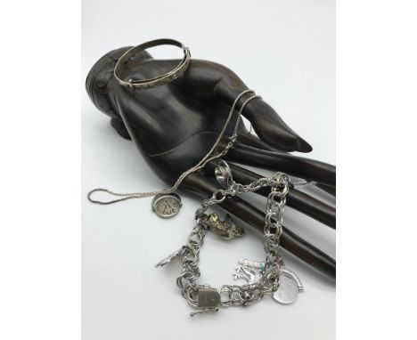 A heavy Sterling silver charm bracelet with various charms, Silver baby bangle and silver necklace 