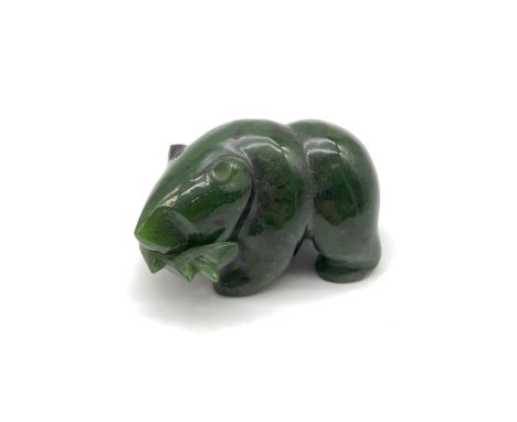 A Oriental Hand carved Jade bear holding a fish within its mouth sculpture. Measures 4x6.5x4cm