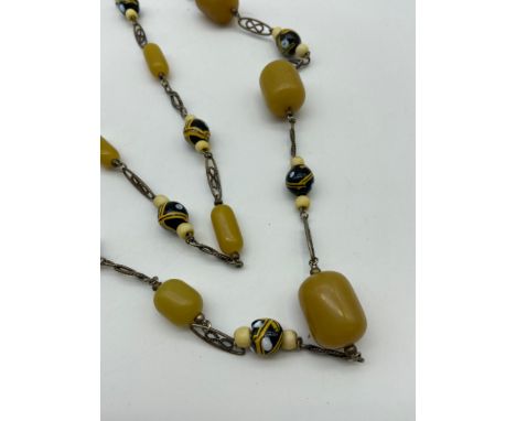 A Vintage ladies necklace designed with amber and glass beads. [20 inch drop]. 