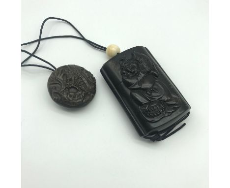A Japanese hand carved inro detailing a carved fisherman, the fish he is holding has a black bead eye. Also signed by the art
