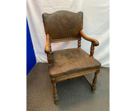 A Victorian Ships oak carver chair. Upholstered with original leather and stud finish. Fitted with centre bracket and has ori