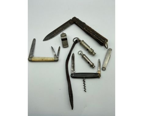 A Lot of antique and vintage whistles and pocket knives, to include 1940 Hudson and co whistle with leather strap and large A