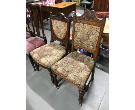 A lot of two Victorian oak 'his &amp; her' parlour chairs, with matching upholstery &amp; ceramic castors 