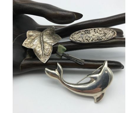 A Lot of 4 silver brooches to include Viking style and green stone axe brooch, Large Dolphin silver brooch, Silver leaf brooc