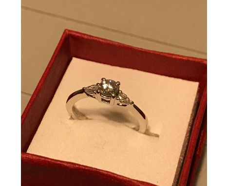 A Beautiful example of a ladies 18ct white gold and Diamond engagement ring. Centre round brilliant diamond (0.28ct) two oute