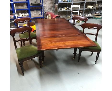 A Victorian extending dining table with turned leg supports and original ceramic castor feet. Together with four Victorian di