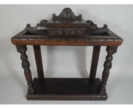 A Late Victorian Oak Hall Stick Stand with Raised Centre Small Drawer having Lion Mask Carving, Shaped Gallery and Plinth Bas