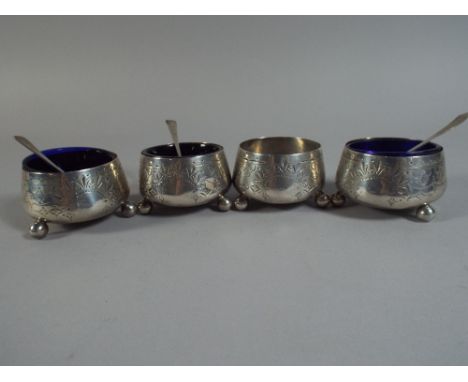 A Set of Four Silver Salts by Edward Hutton, Three with Blue Glass Liners and together with Three Spoons. Ball Feet and Etche