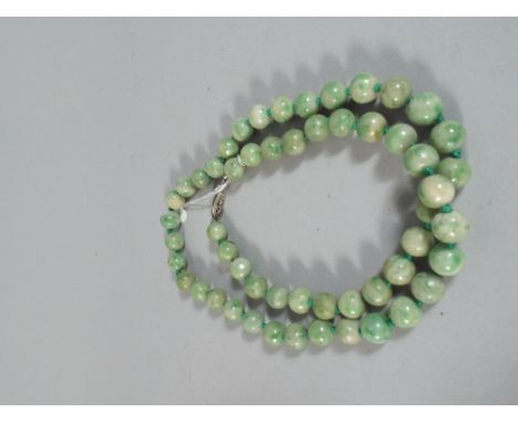 A Necklace Comprising 54 Spherical Green Jade Beads with White Metal Clasp. Beads Measuring 9mm Diameter. 