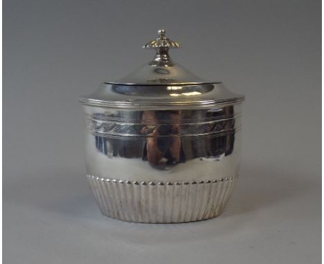 A Small Oval Silver Tea Caddy with Hinged Lid and Ribbed Decoration to Body. London 1892. 10.5cm High