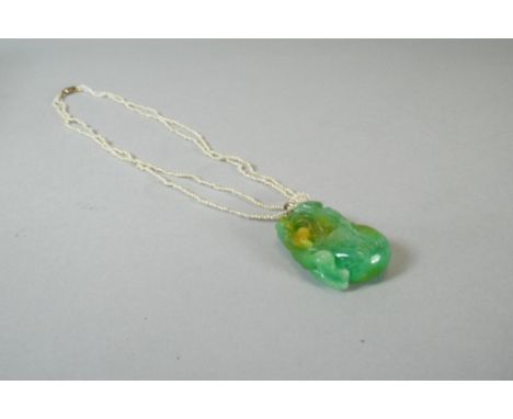 An Oriental Carved and Pierced Jade Pendant Set on Double Pearl Chain. 3.5cm Long. Total Weight 19gms.