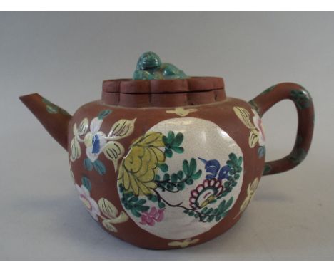 A Chinese Yixing Enamelled Teapot Decorated with Flowers. The Lobed Cover with Temple Lion Finial. 