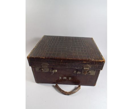 A Late 19th Century Lidded Crocodile Skin Fitted Travelling Case Containing Various Silver Topped Glass Bottles, Ivory Brushe