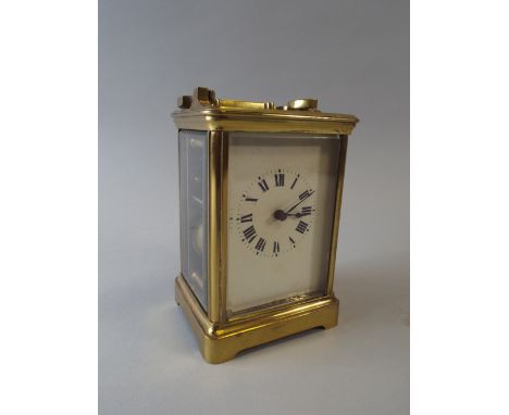 A French Brass Cased Carriage Clock with Eight Day Movement, White Enamel Dial and Roman Numerals. Striking on Gong. 