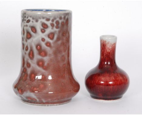 Two Cobridge Pottery vases, the first of elephants foot form decorated in a sang de beouf type glaze with a blue interior, he