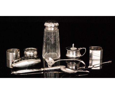 A small parcel lot of silver items to include a caddy spoon, cream ladle, a sugar sifter, three napkin rings, two butter kniv