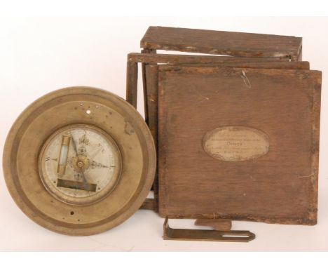 An early 19th Century circular brass compass, the silvered compass dial engraved Cole Fecit within a distressed mahogany case