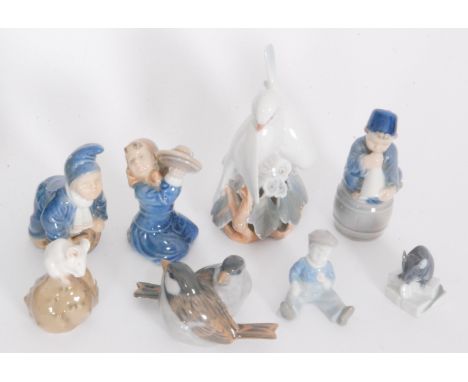 Seven assorted Royal Copenhagen figures comprising two white doves, model 402, two finches, model 1309, a boy sat on a barrel