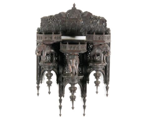 A late 19th to early 20th Century Anglo Indian fret work hardwood bracket shelf or plateau, the upper frieze panel carved wit