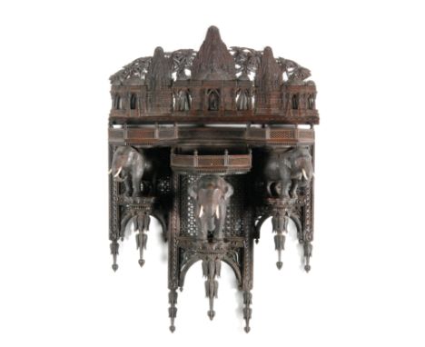 A late 19th to early 20th Century Anglo Indian fret work hardwood bracket shelf or plateau, the upper frieze panel carved wit