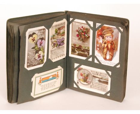 An early 20th Century postcard album containing a variety of humorous, portrait, scenic and military cards, approximately one