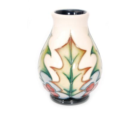 A Moorcroft Pottery vase decorated in the Christmas Holly pattern designed by Philip Gibson, height 9.5cm.