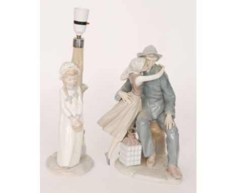 A large Lladro figurine modelled as a seated man welcoming a lady into his arms with a lamp below, printed mark, height 34cm 