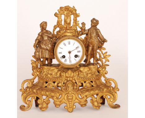 A 19th French gilt spelter mantle clock with circular white enamelled dial and eight day movement striking on a bell, the roc