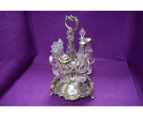 A Victorian silver plated rotating condiment centre piece, having floral detailing and handle on three footed base.