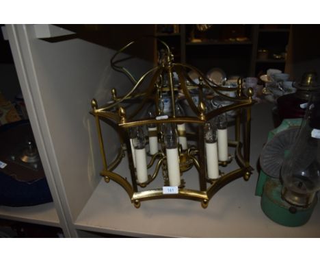 A brass framed centre light having candle effect bulb holders.