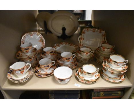 A partial Wellington china dinner service including cups and saucers and plate with floral transfer pattern.