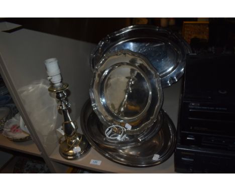 A selection of silver plated items including lamp base serving trays and dishes