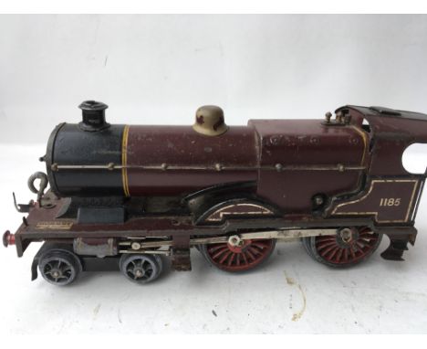 A Hornby tinplate clockwork engine an tender numbered 1185 in a maroon colour some repair needed