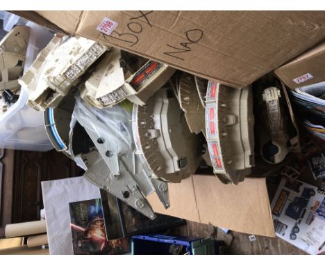 A collection of vintage and newer Star Wars Millenium Falcon shells and spare parts