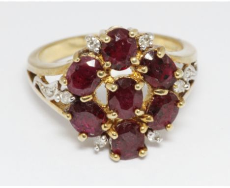 A hallmarked 9ct gold ruby and diamond cluster ring, the cluster measuring approximately 16mm in diameter, gross weight 5g, s