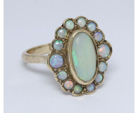 An opal cluster ring, the cluster measuring approximately 19mm x 16mm, hallmarked 9ct gold, sponsor 'HBJ', London 1995, gross