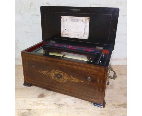 A 19th century Swiss music box, six airs, playing on combs and reed organ, cabinet length 62cm. Condition:- General wear thro