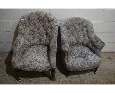 Two Victorian button back armchairs with faded floral upholstery