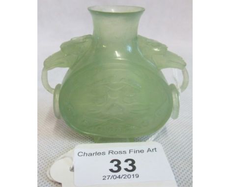 A 20th century Chinese carved jade miniature flask of flattened form, with captive ring handles. 